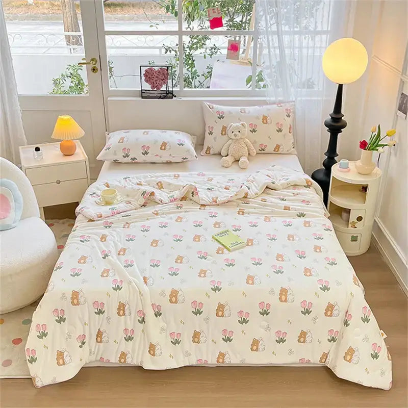 Cream-colored quilted kids summer quilt with soft pastel brown bear and pink tulip pattern by decorbites kids summer