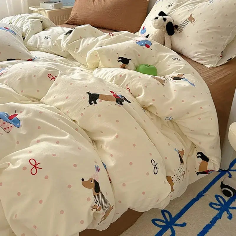 Cream-colored satin quilt cover set featuring playful cartoon dachshunds and cupcakes on soft cotton fabric