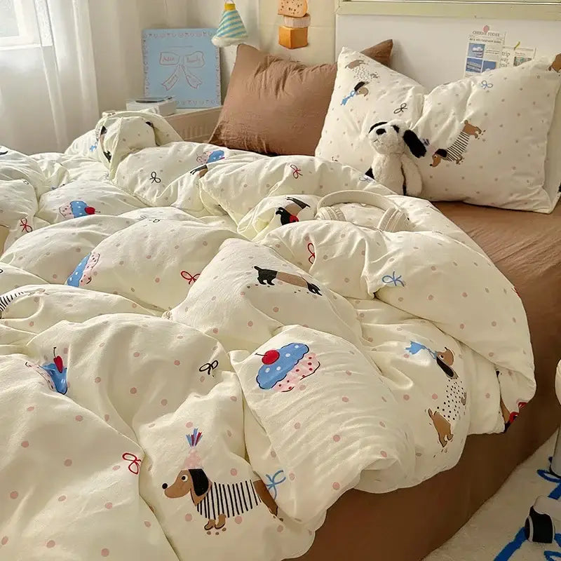 Cream-colored satin quilt cover set featuring playful cartoon dachshund and cupcake prints on soft textured fabric