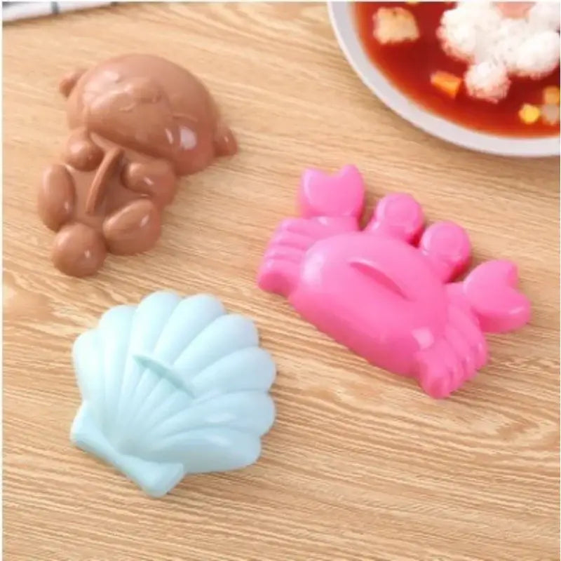 Cartoon animal sushi mold set with three colorful silicone molds in brown bear pink crab and light blue seashell shapes