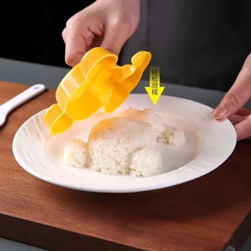 Yellow plastic dinosaur-shaped rice mold from decorbites cartoon animals sushi and sandwich mold set for kids bento