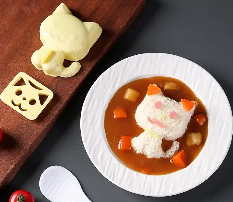 A white ceramic plate with a cat-shaped rice dish in curry sauce made using decorbites cartoon animals mold set