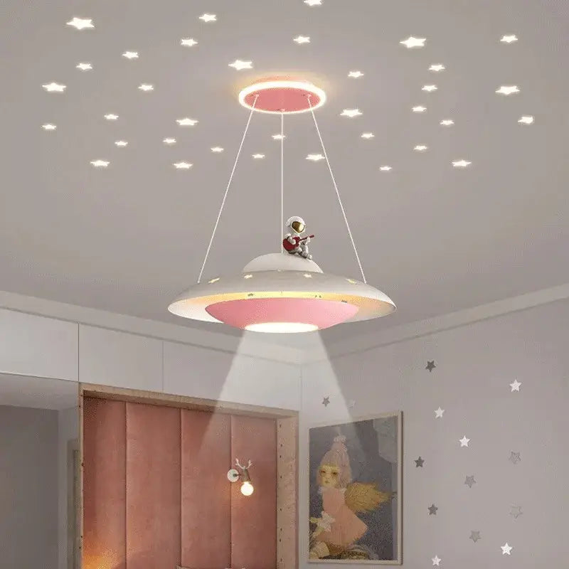 Whimsical ufo-shaped pendant light with pink and white design featuring decorbites cartoon astronaut chandelier playing guitar