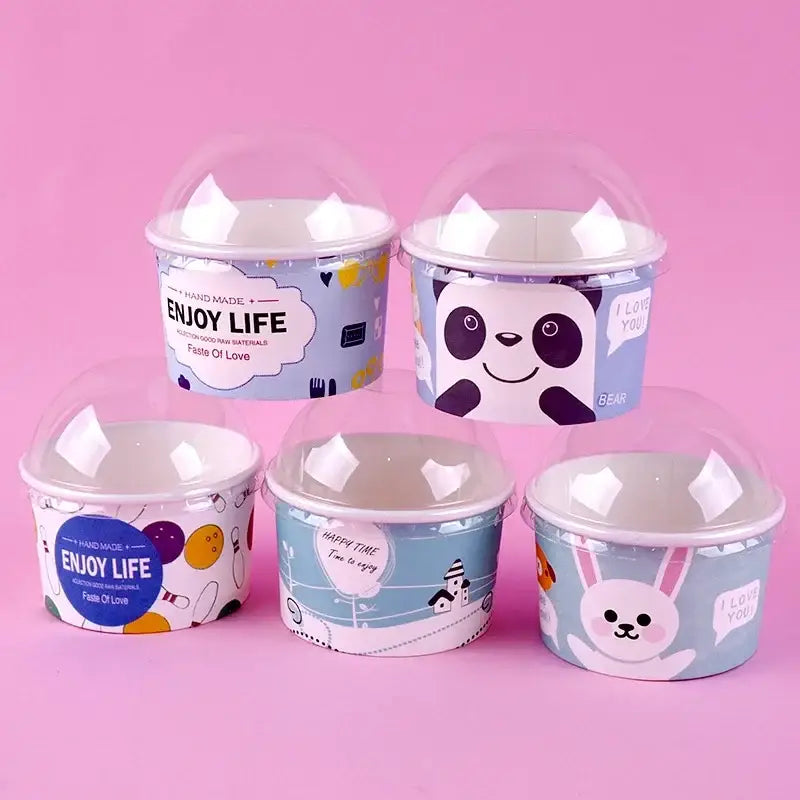 Cartoon blue and white paper cups with lids featuring playful panda and rabbit designs for dining room dessert use
