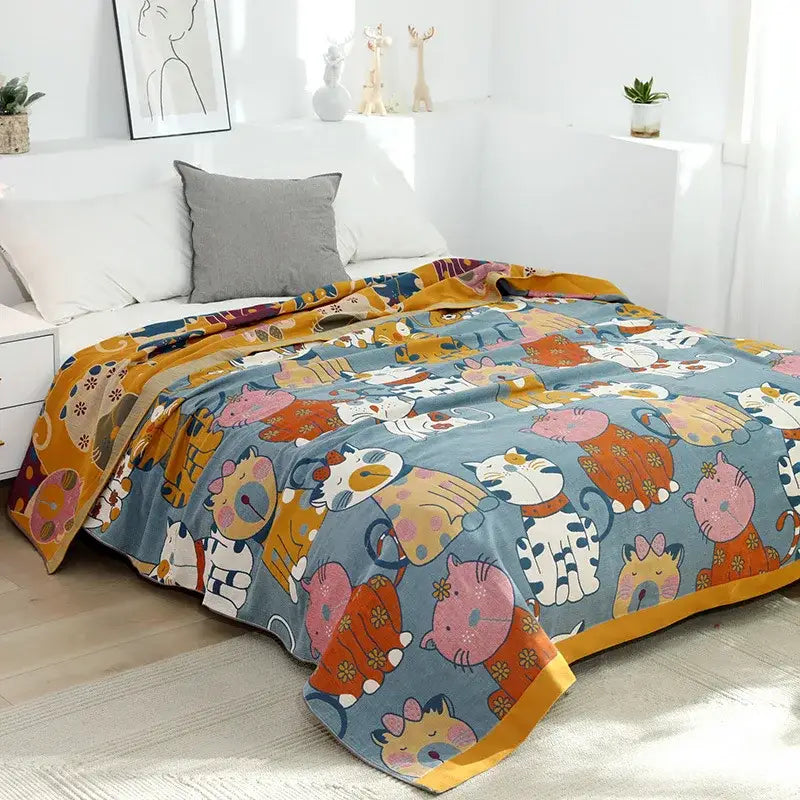 A cozy blue woven cotton decorbites cartoon boho bedspread featuring playful cats in colorful outfits with yellow trim