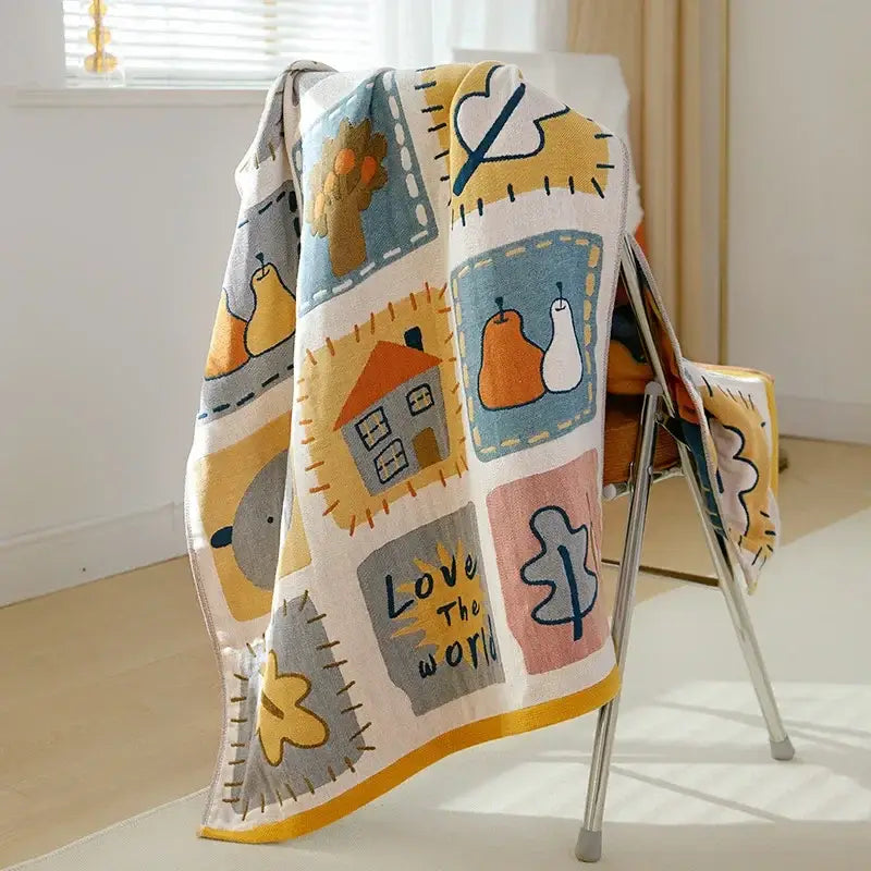 A cream-colored cartoon cat and dog cotton gauze bath towel with playful patchwork and yellow trim by decorbites cotton gauze