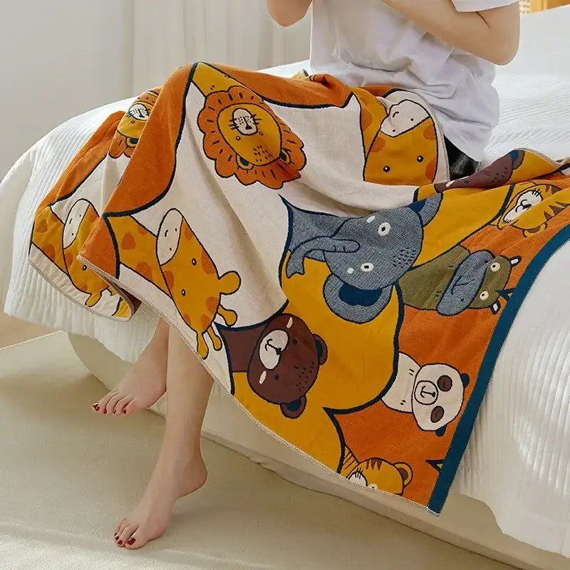 A cozy cotton gauze bath towel featuring playful cartoon animals in warm tones for bathroom use by decorbites cotton gauze