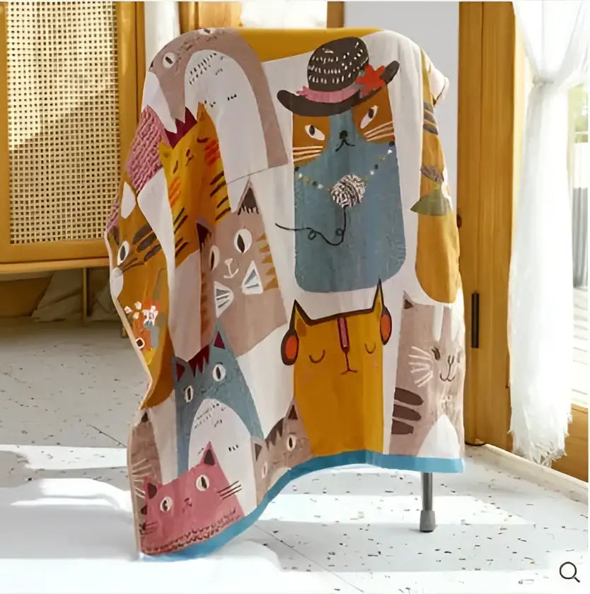 A cotton gauze bath towel featuring a soft texture and playful cartoon cats for bathroom use by decorbites