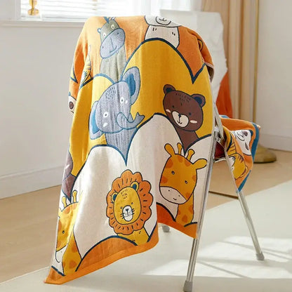 A soft yellow and white cotton gauze bath towel with cartoon animals including elephant and lion for bathroom use