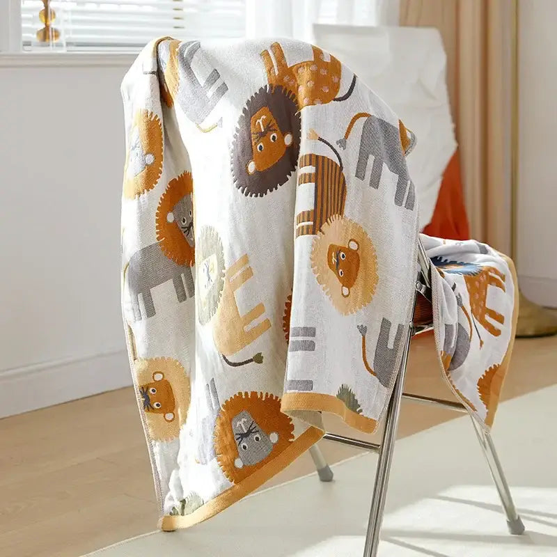 A soft white cotton gauze bath towel with playful orange and gray cartoon lion pattern by decorbites bath towel