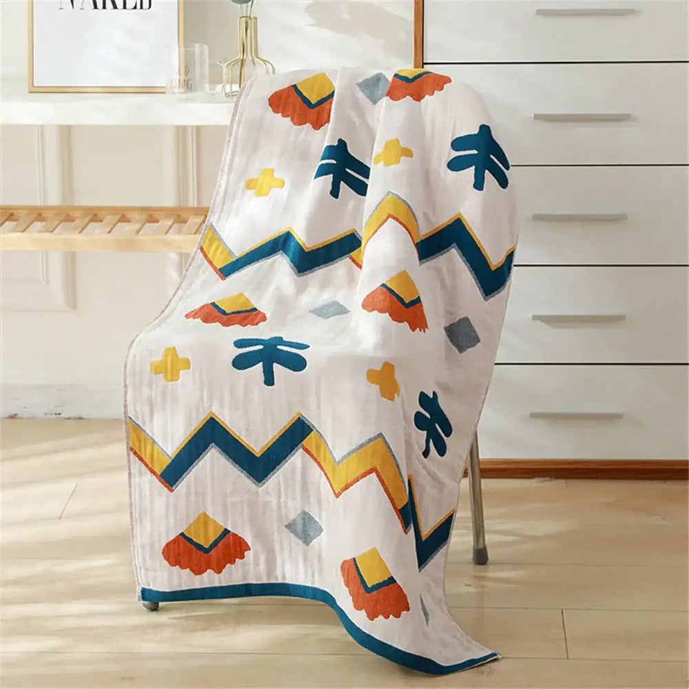 A white cotton gauze bath towel with orange yellow and teal geometric shapes for bedroom and nursery decorbites cotton gauze