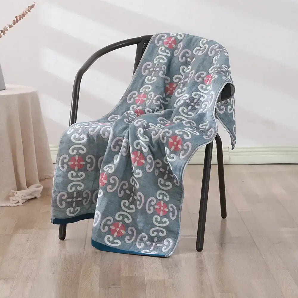 A soft blue cotton gauze bath towel with pink and white floral motifs for bedroom and nursery decorbites cotton gauze