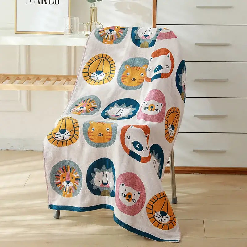 A soft white decorbites cotton gauze bath towel with colorful cartoon lions and tigers for bedroom and nursery decor