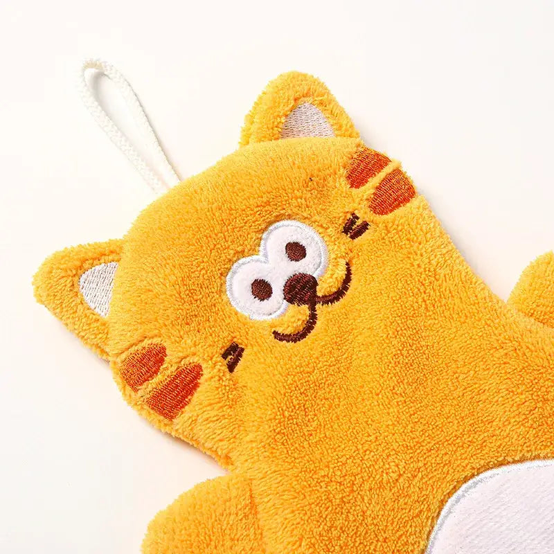 A bright yellow plush coral velvet hand towel shaped like a cartoon cat with white eyes and orange paw patches for decorbites cartoon cat decor