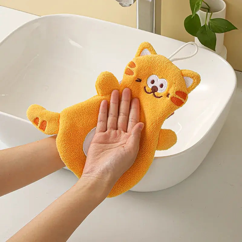 A plush orange cartoon cat coral velvet bath sponge with embroidered face and white loop handle for hand towels decorbites cartoon cat bathroom decor