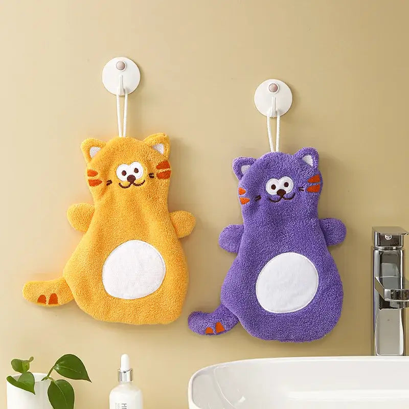 Two plush cartoon cat coral velvet hand towels in yellow and purple with embroidered features for bathroom decorbites decor