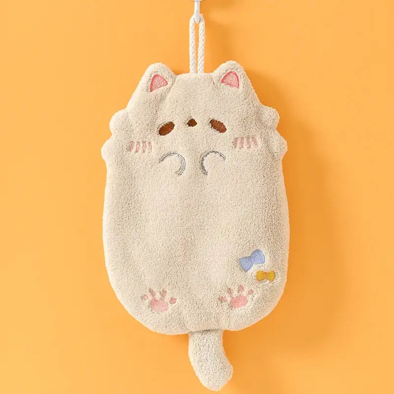 A cream-colored plush cartoon cat hand towel with pink embroidered details made of microfiber for kitchen cleaning decorbites cartoon cat