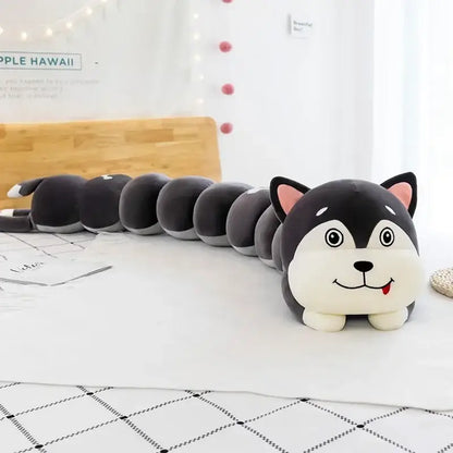 A plush husky-shaped long body pillow with black and white fur and pink ears for bedroom use as a cartoon caterpillar body pillow
