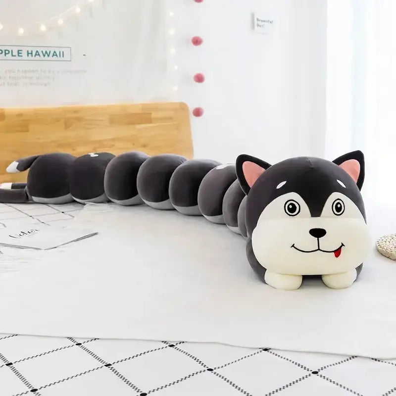 A plush husky-shaped long body pillow with black and white fur and pink ears for bedroom use as a cartoon caterpillar body pillow
