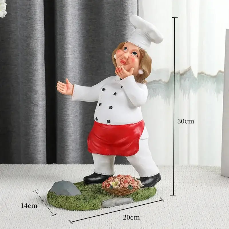 A charming 30cm resin cartoon chef wine rack with white coat red apron tall hat standing on grassy base decorbites cartoon chef