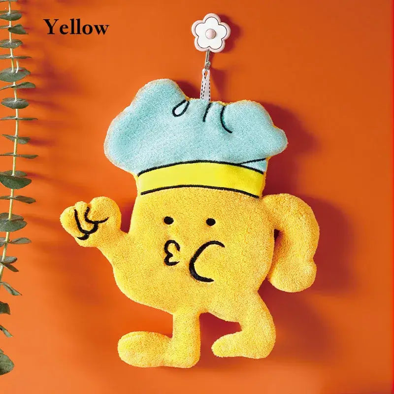Yellow plush cartoon chef microfiber hand towel with light blue hat hanging from flower-shaped kitchen wall hook