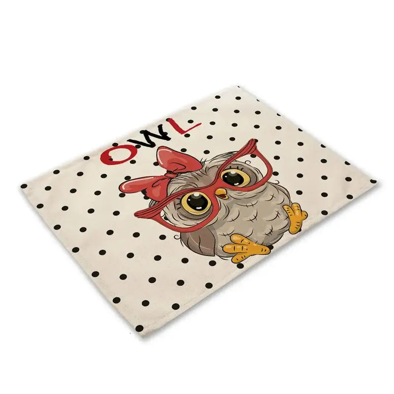 Cute owl animal dining table placemats set featuring a gray owl with red glasses on cream fabric with black polka dots