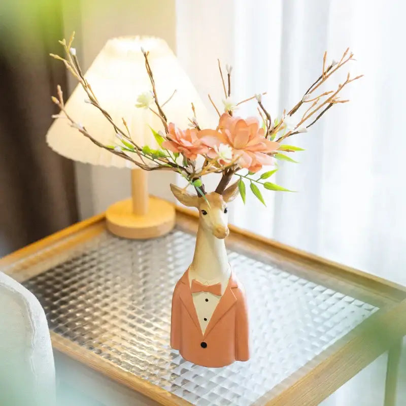 A ceramic cartoon deer vase in beige and orange resin with peach and white blossoms for living room decor
