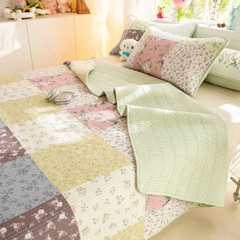 Pastel patchwork cartoon dinosaur green cotton quilted bed cover set with floral patterns in soft greens pinks and creams
