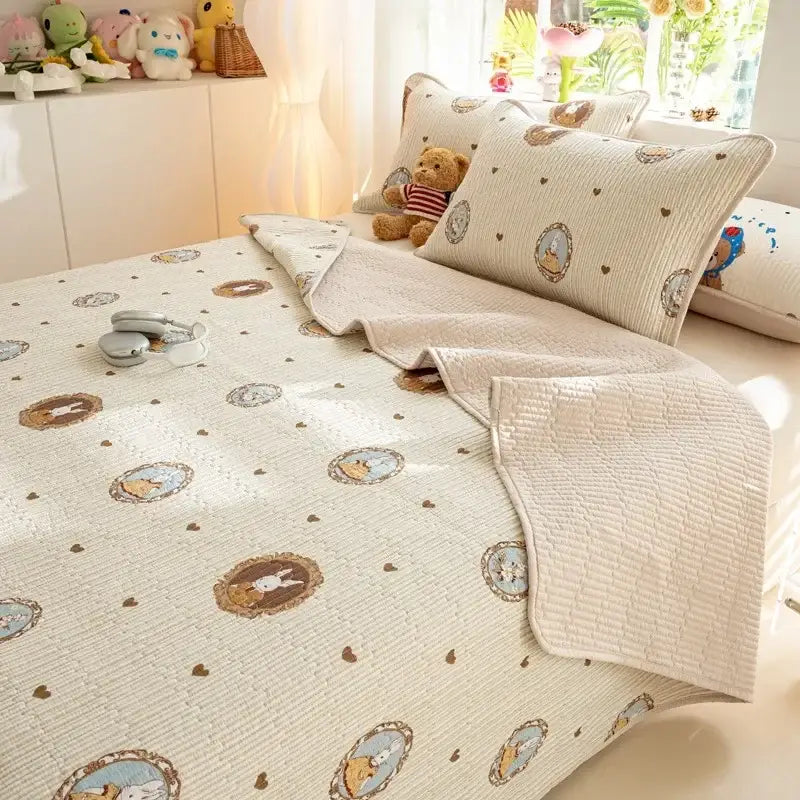 Beige quilted cotton bed cover set with embroidered cartoon animal motifs and brown heart patterns for bedroom use