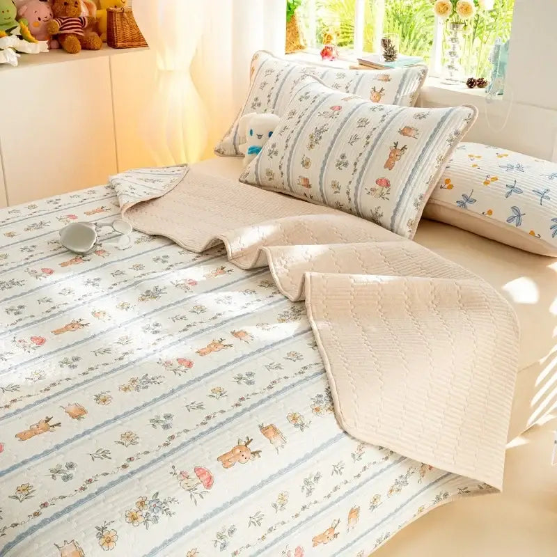 Beige quilted cotton bed cover set featuring cartoon deer and floral motifs in muted blues and browns for bedroom use