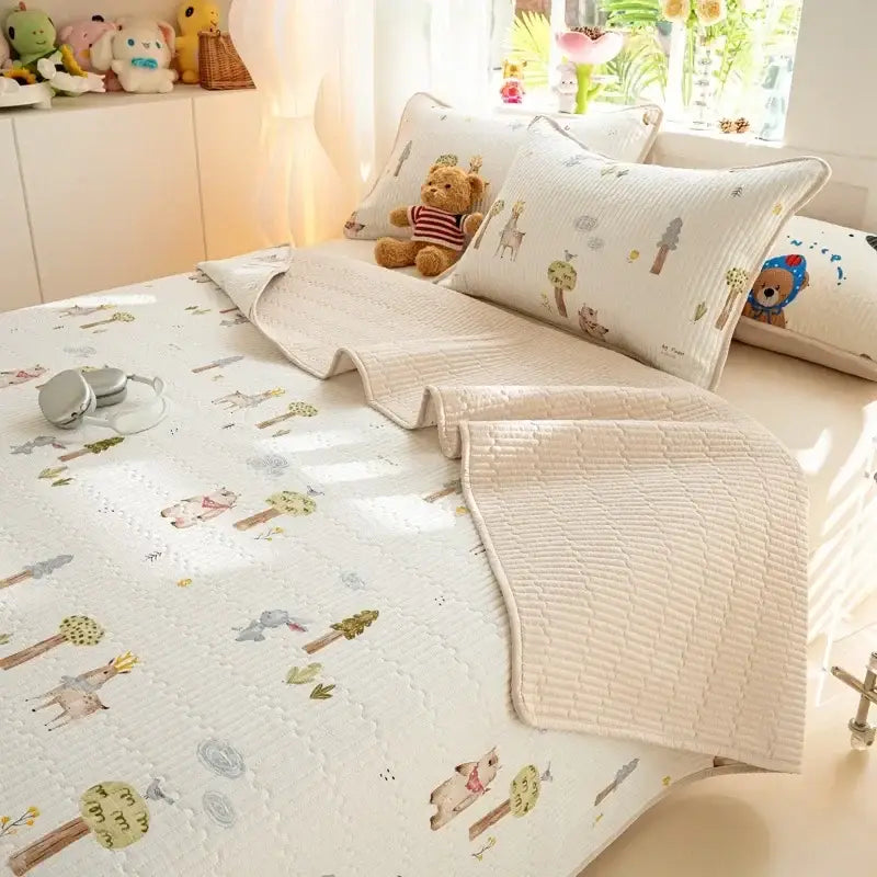 Cream-colored quilted cotton bed cover set with whimsical forest animal print featuring deer and trees in pastel tones