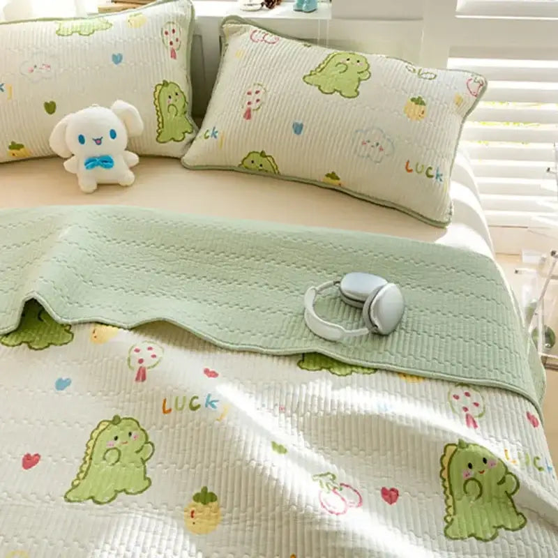Light green quilted cotton bed cover set with playful cartoon dinosaurs and hearts for bedroom use