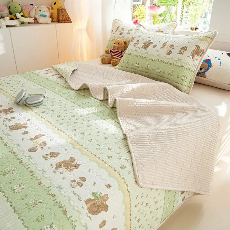 Soft quilted cotton bed cover set in mint green and cream with embroidered woodland animal motifs for bedroom use