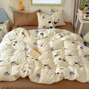 Cream cotton fitted sheet set featuring a quilted duvet cover with cartoon dogs and cupcakes pattern