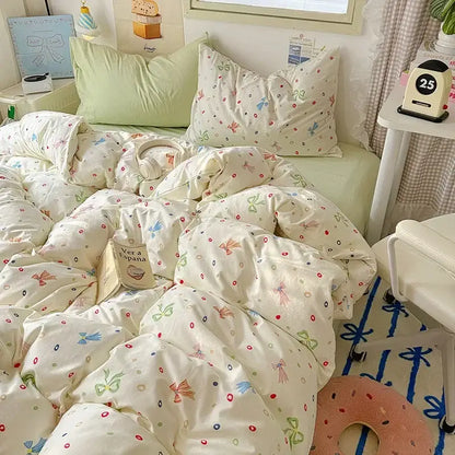 Cream-colored cotton fitted sheet set with playful pastel bows dots and tiny birds for bedroom bedding use