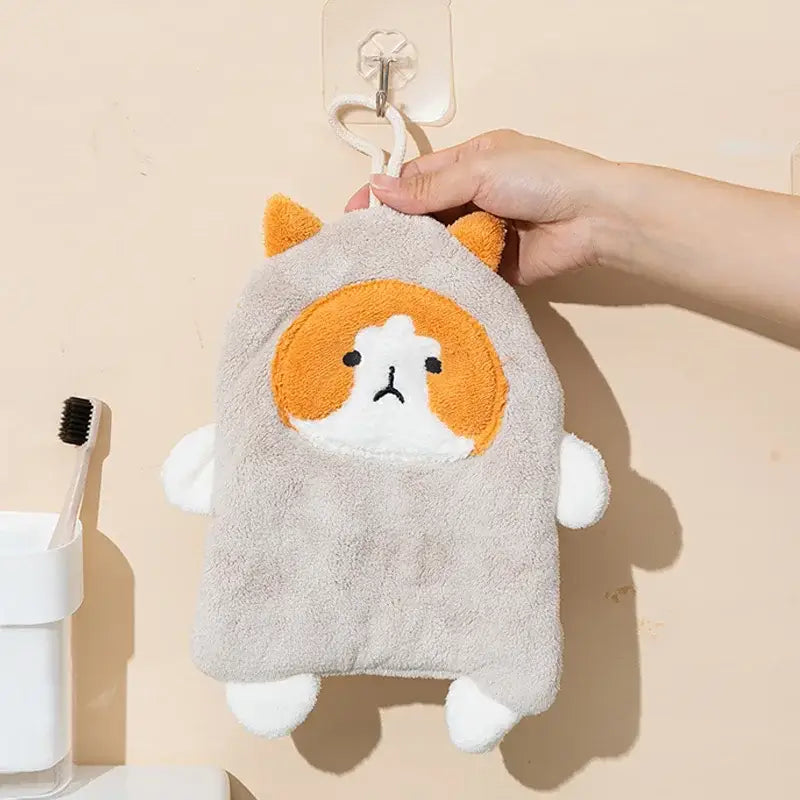 A soft gray coral velvet bath sponge shaped like a cat with orange ears and white paws for decorbites cartoon dog hand towels