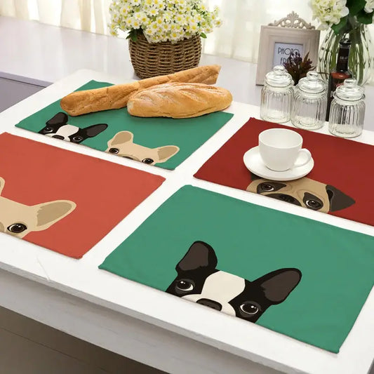 Set of four cotton linen dining table mats with colorful cartoon dog illustrations on green red and orange backgrounds