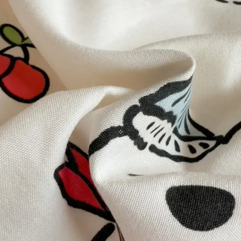 Cream comforter bedding set with playful red cherry and black white floral print in decorbites cartoon style
