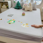 Light gray textured mattress pad with decorbites cartoon embroidered playful cat and christmas tree appliqués fitted sheet
