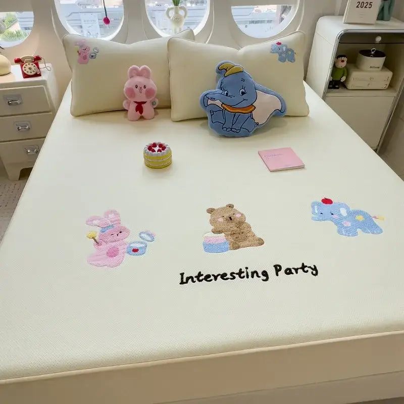Cream-colored fitted sheet with decorbites cartoon embroidered characters and interesting party text on mattress pad
