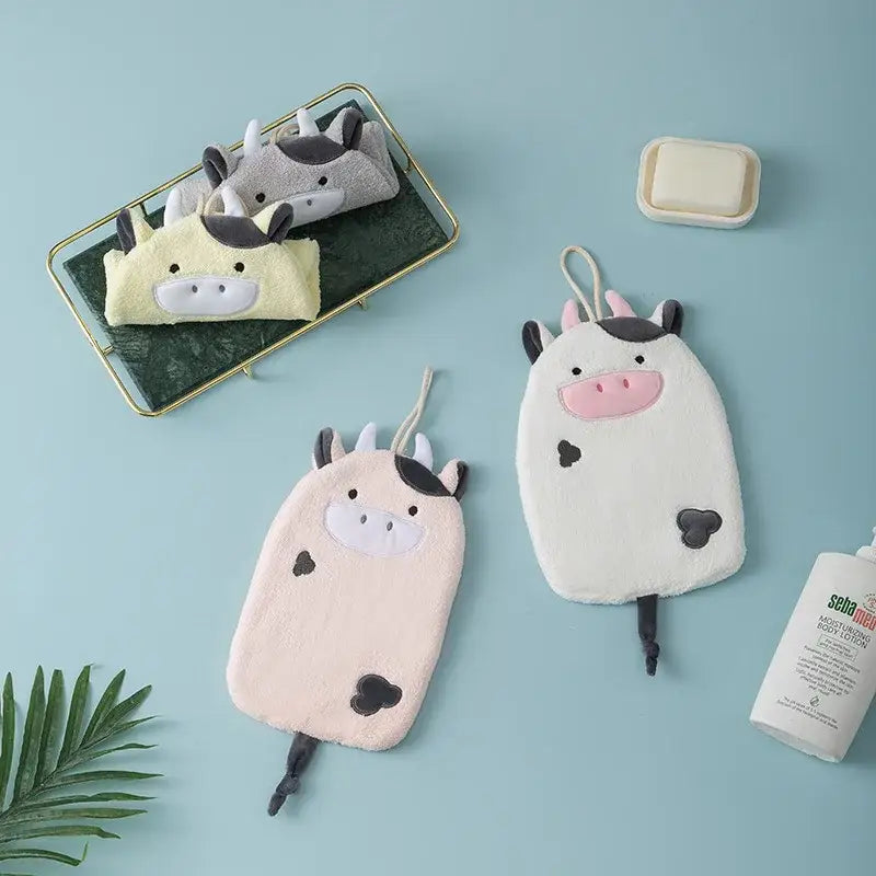 Soft plush cow-shaped hand towel in pastel pink and white with decorbites cartoon embroidery hanging design