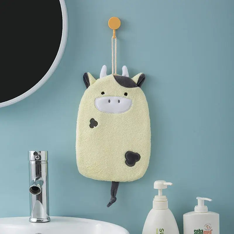 A soft pale yellow cow-shaped hand towel with black spots and ears hanging decorbites cartoon embroidery hanging design