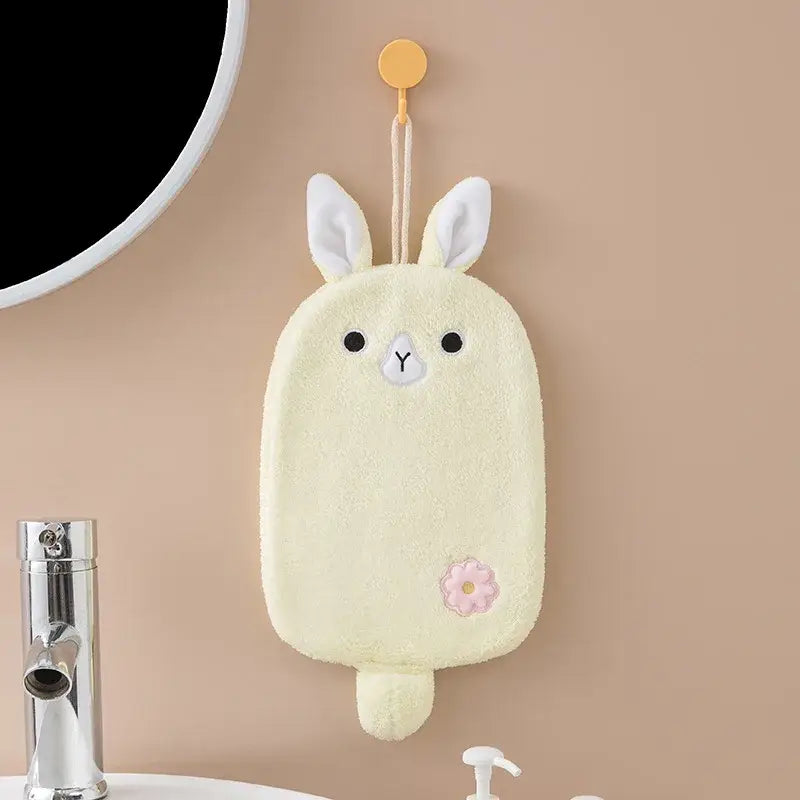 A soft pale yellow bunny-shaped hand towel with white embroidered ears and pink floral patch for decorbites cartoon embroidery hanging