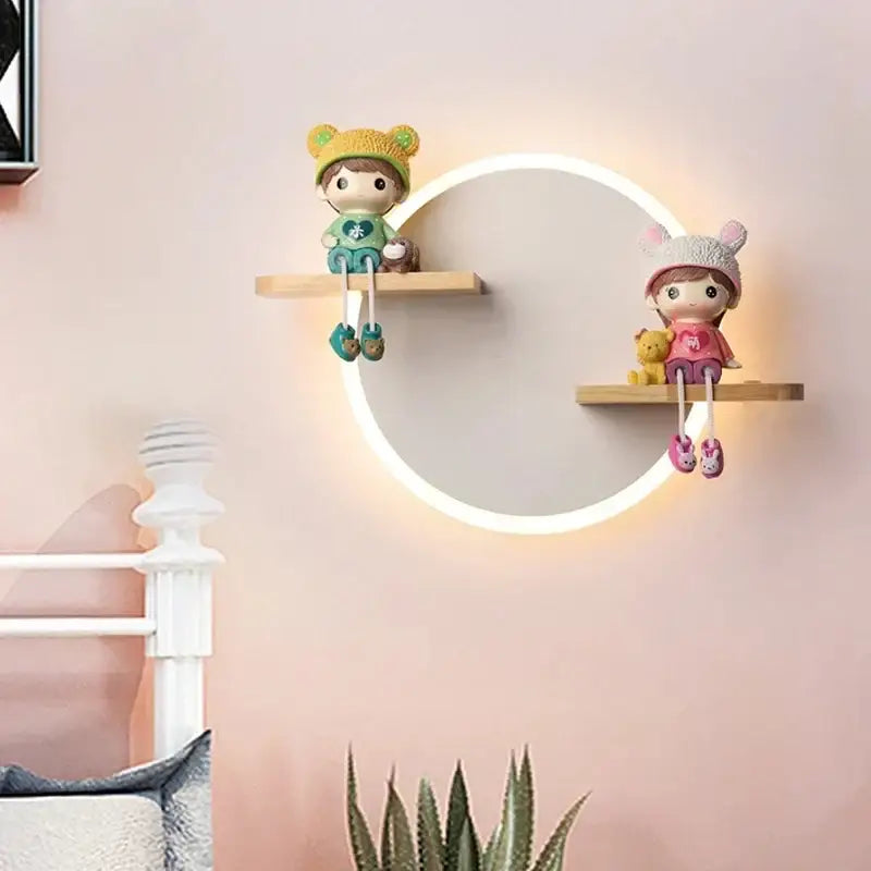 Cute cartoon figurines with knit hats sit on wooden shelves above a decorbites led wall lamp for bedroom decor