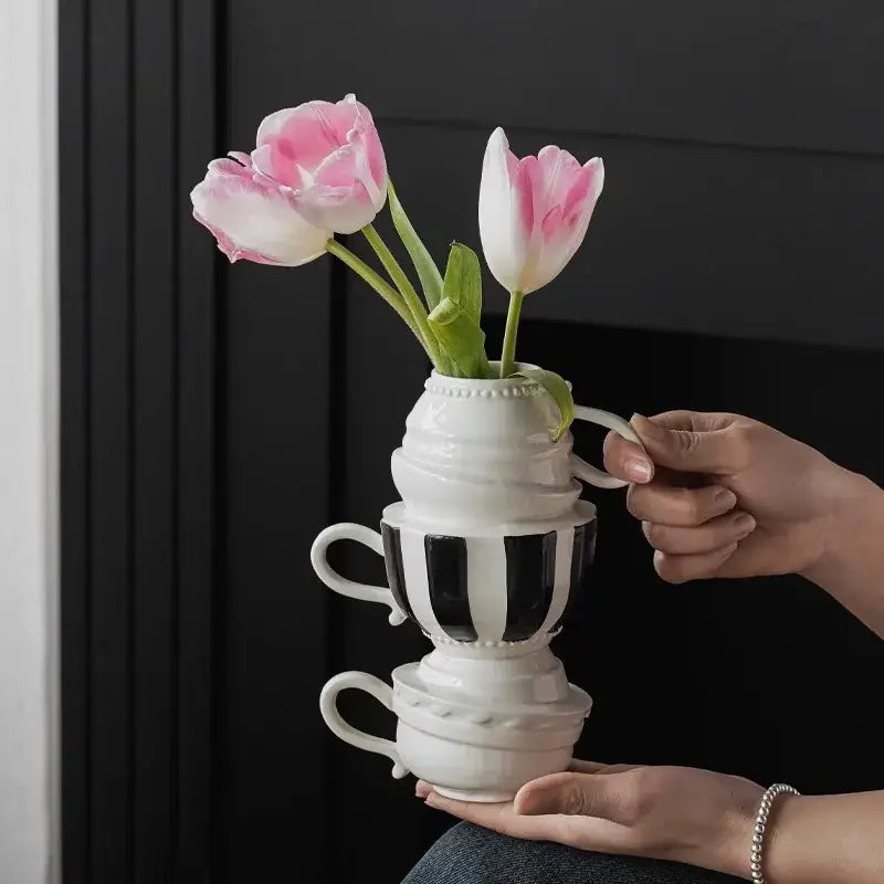 A white ceramic cartoon folding cup vase with one black and white striped cup ideal for living room decorbites decor