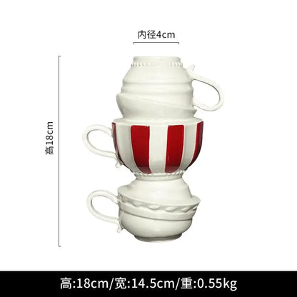 A whimsical cartoon folding cup ceramic vase with stacked white and red striped folding cups for living room decor