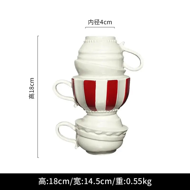 A whimsical cartoon folding cup ceramic vase with stacked white and red striped folding cups for living room decor