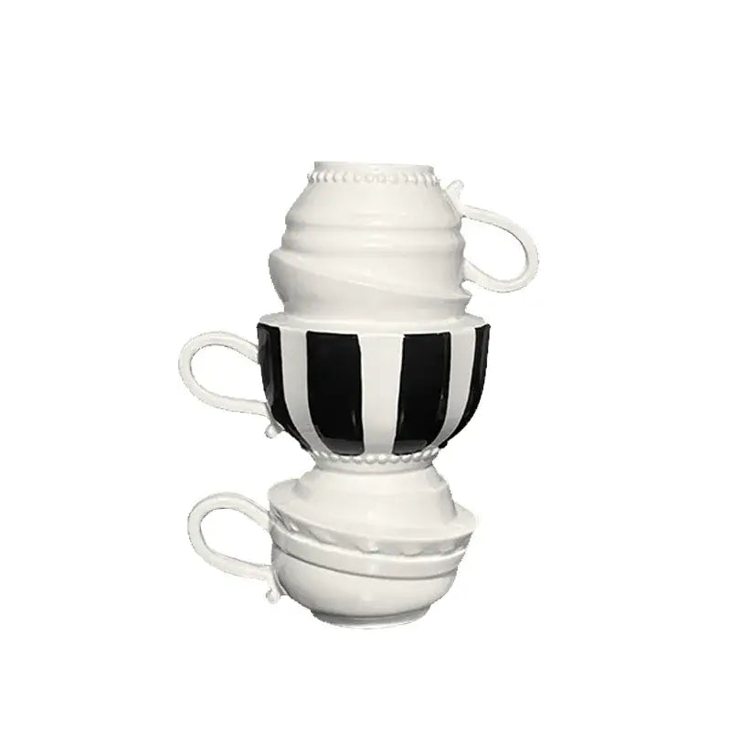 Stacked black and white ceramic folding cups with decorative beaded rims and bold striped central cup for decorbites cartoon folding decor
