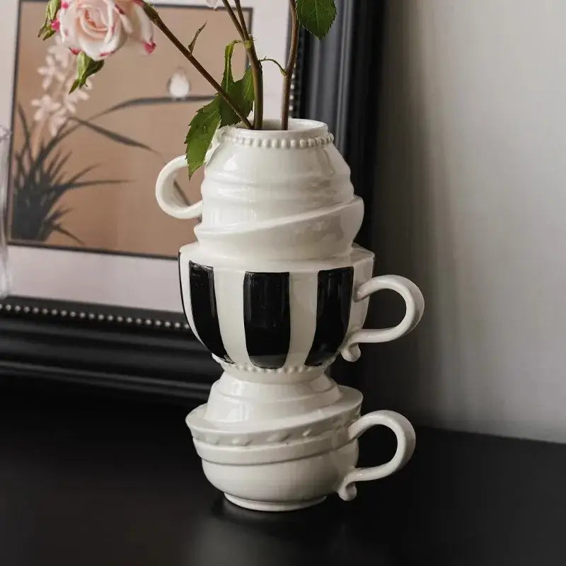 A white ceramic cartoon folding cup vase with bold black vertical stripes for living room decorbites decorbites folding cup