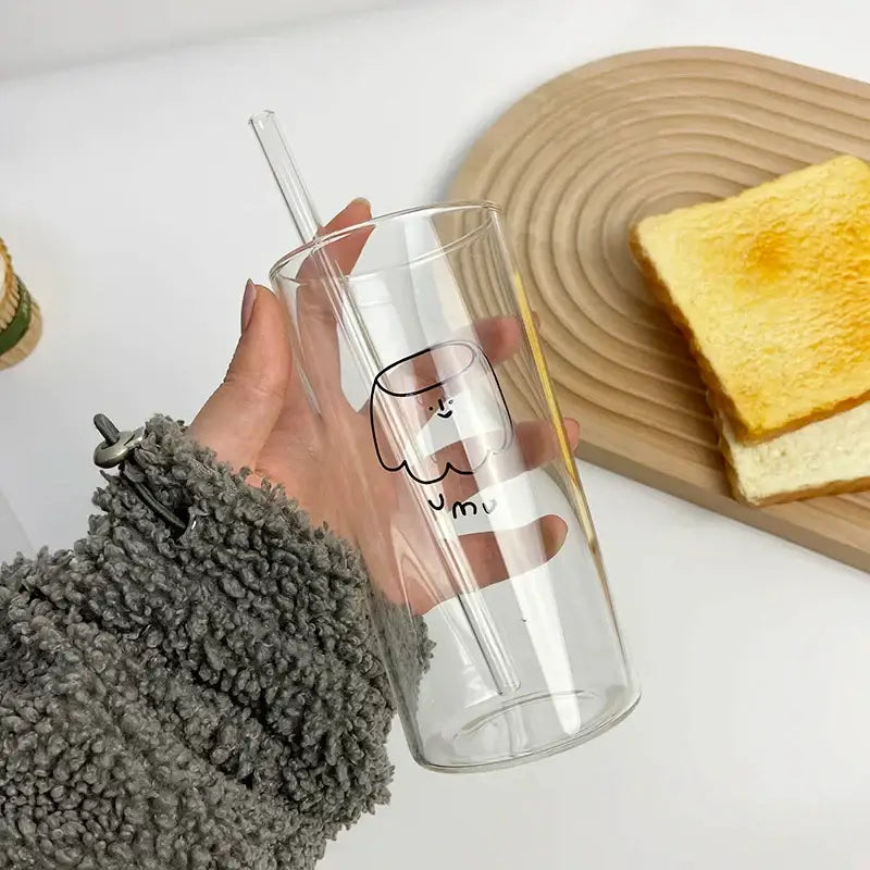 Clear glass cup with minimalist cartoon face design and matching transparent straw from decorbites cartoon glass collection